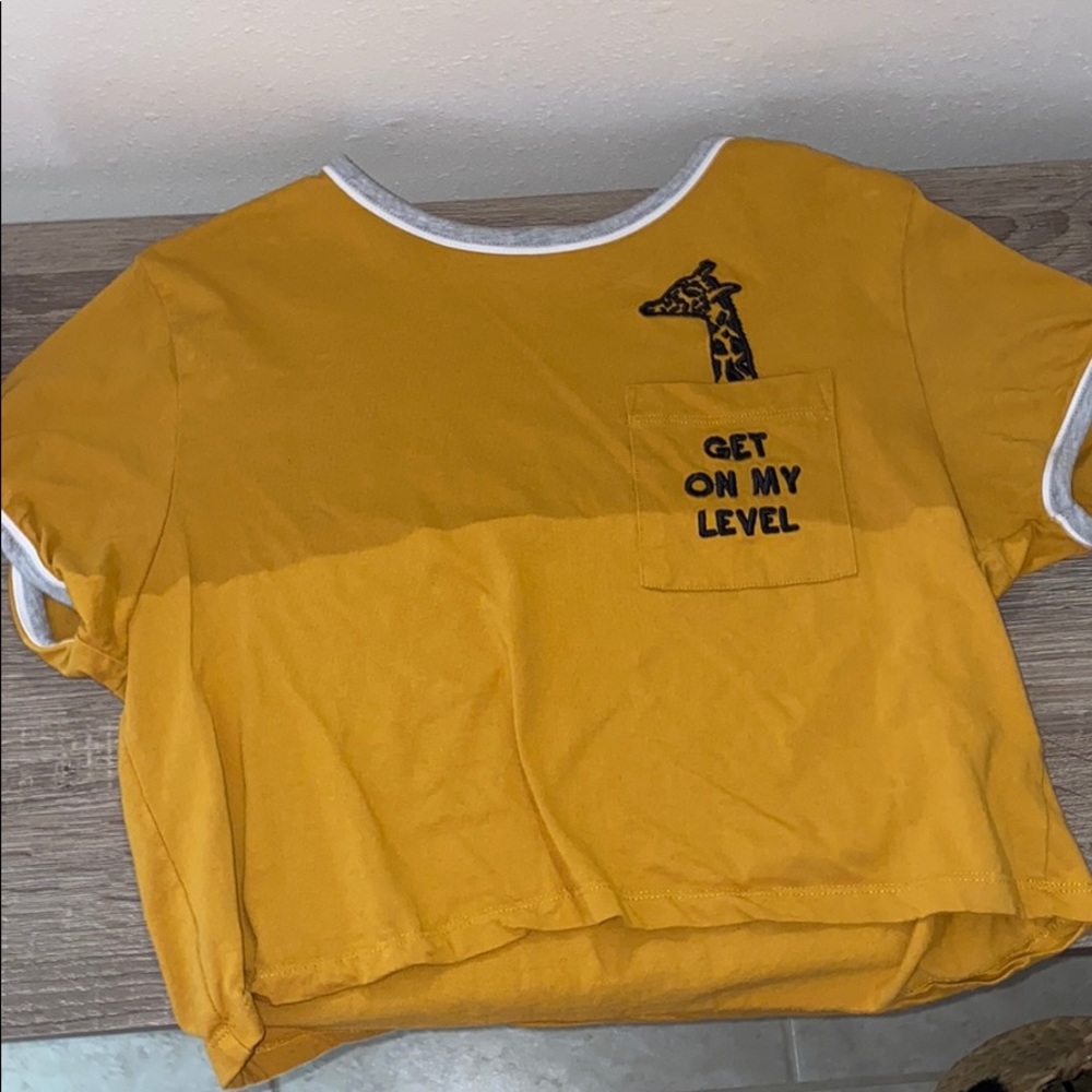Mustard yellow graphic crop top with pocket.